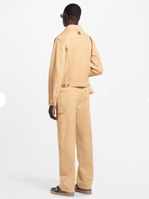 Person wearing a beige jacket and pants on a white background