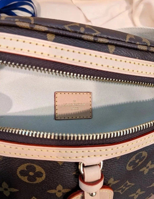 Close-up of a Louis Vuitton bag with monogram pattern and visible brand logo.