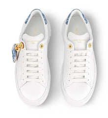 White sneakers with decorative elements on a white background