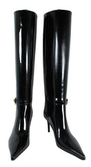Black patent leather knee-high boots on a white background