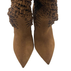 Pair of brown suede boots with woven ankle straps on a light gray background