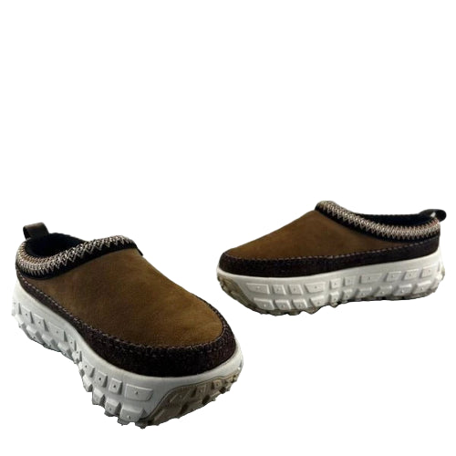 Pair of brown slip-on shoes with white soles on a gray background