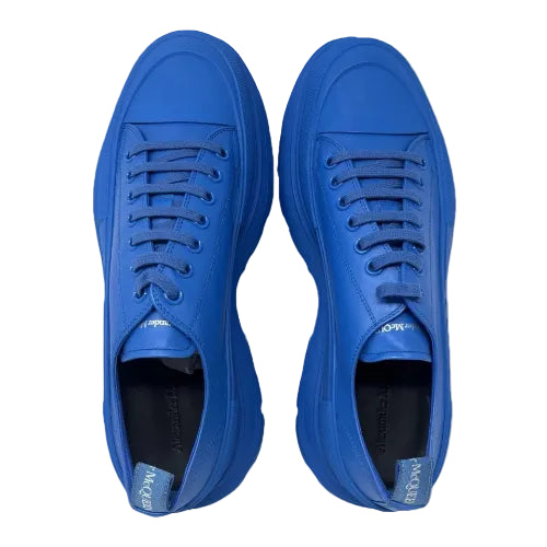 A pair of bright blue low-top sneakers shown from a top-down view on a plain white background.