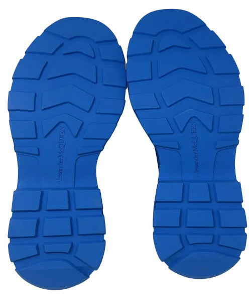 A pair of blue rubber shoe soles shown from above on a white background, featuring deep tread patterns and embossed branding.