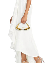 A woman wearing a white high-low dress and white high heels, holding a gold handbag. The image is cropped to show the dress, handbag, and feet against a plain white background.