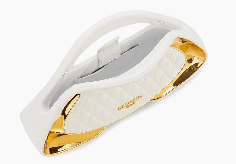 A white and gold ring with a smooth, glossy finish, shown on a plain white background.
