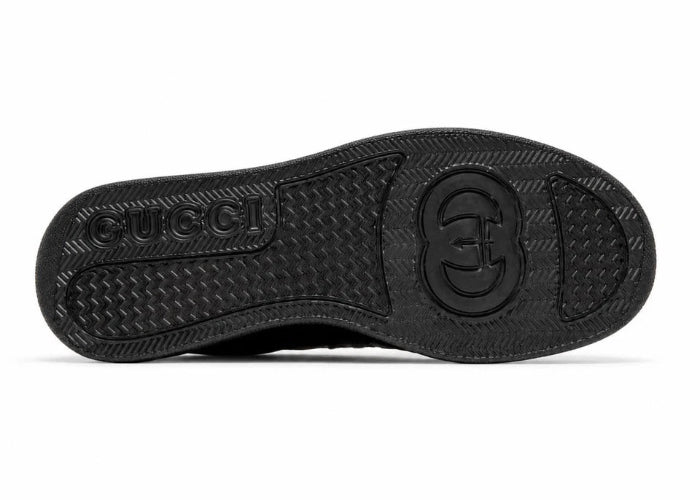 Black rubber outsole of a sneaker, showing the tread pattern and embossed logo on a plain white background.