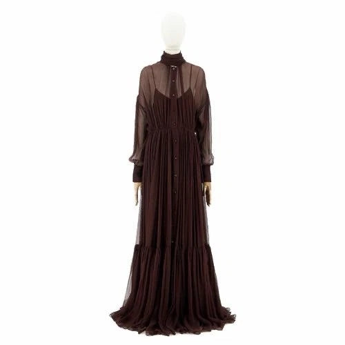 A dark brown long-sleeved maxi dress with a sheer mesh high-neck overlay and a pleated skirt, displayed on a white mannequin against a plain white background.