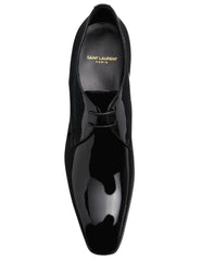 A single Saint Laurent black patent leather oxford shoe shown from a top-down perspective against a light gray background.