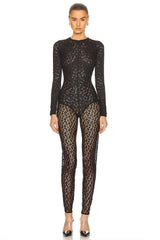 Person wearing a black lace bodysuit on a white background