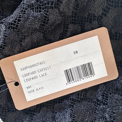 Clothing tag with product details on a black background