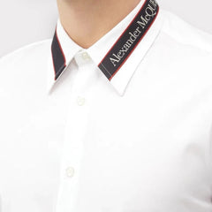 White shirt with a visible brand label on a white background