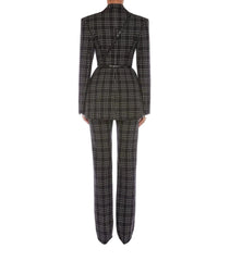 A model shown from the back wearing a matching black and beige plaid blazer and trousers set, featuring structured shoulders, a peplum waist, and straight-leg pants, set against a plain light gray background.