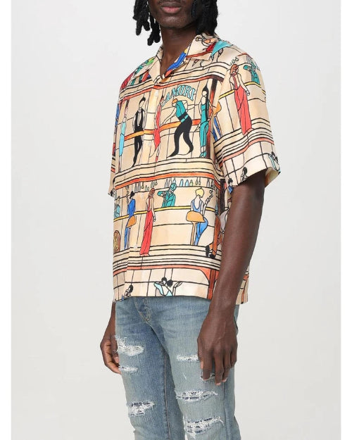 Person wearing a colorful patterned shirt with a neutral background