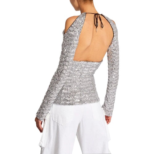 Silver sequin top with long sleeves and open back on a plain background