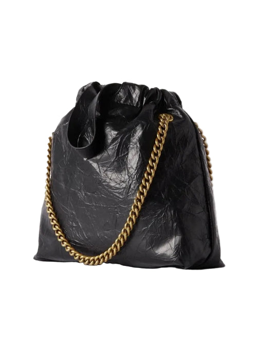 Black textured handbag with a gold chain on a white background