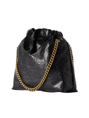 Black textured handbag with a gold chain on a white background