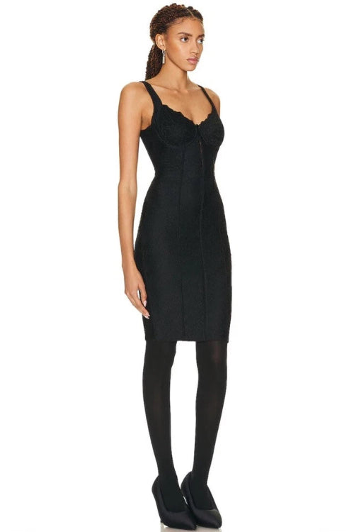 A woman modeling a black sleeveless camisole-style top and black leggings against a plain white studio background.