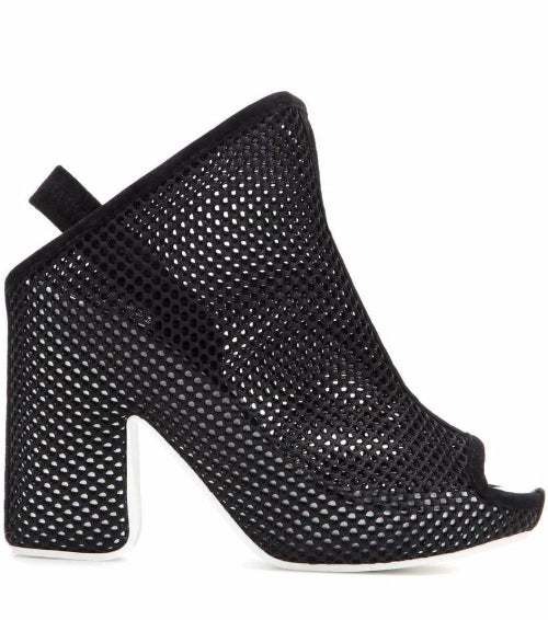Black perforated high-heeled shoes on a white background