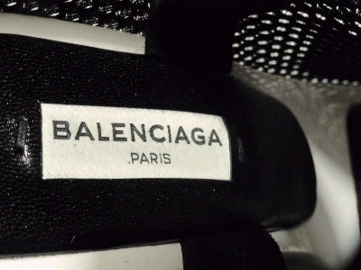 Balenciaga label on a black textured surface
