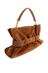 A brown suede handbag with a structured rectangular shape, a draped front detail, and a top handle, shown against a plain white background.