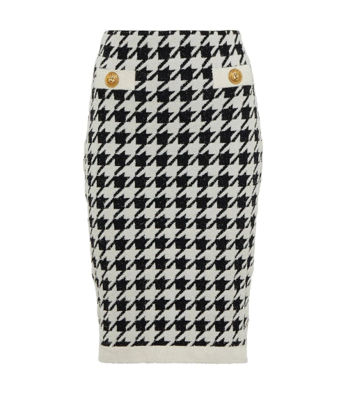 Houndstooth patterned skirt with gold buttons on a white background