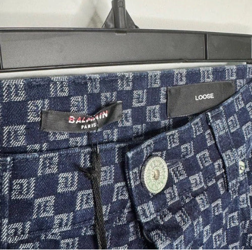 Close-up of a patterned fabric with a brand label on a dark background