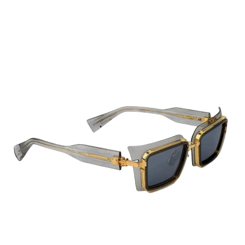 Sunglasses with gold frame and black lenses on a white background