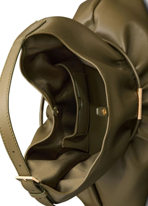 Close-up of a large olive green leather shoulder bag with a slouchy silhouette, showing the interior lining, strap attachment, and small gold-tone hardware on a white background.