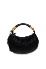 A black fur crescent shoulder bag with a braided black handle and gold-tone hardware, shown against a plain white background.