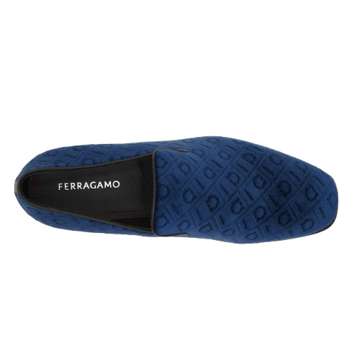 A single dark blue fuzzy slip-on shoe shown from the side against a plain white background.