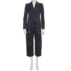 A dark navy blue two-piece suit with contrasting light piping and gold buttons, displayed on a white mannequin against a light gray background.