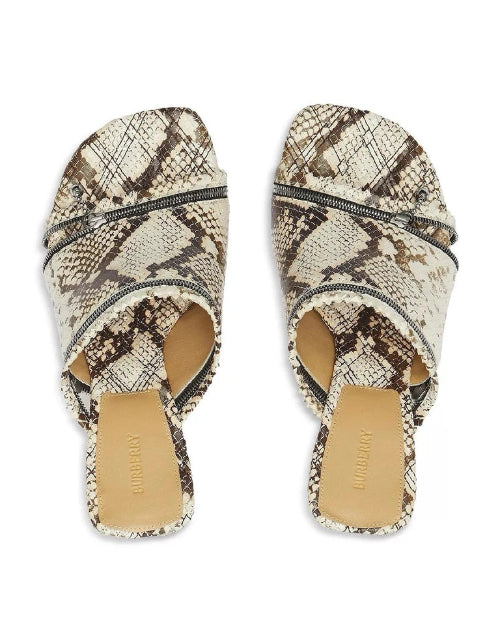 Pair of snake print sandals on a white background