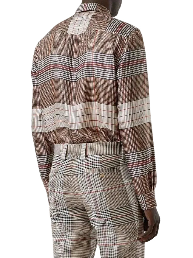 A man wearing a brown and beige plaid long-sleeve shirt and matching trousers, shown from the back against a light gray background.