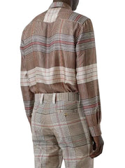 A man wearing a brown and beige plaid long-sleeve shirt and matching trousers, shown from the back against a light gray background.