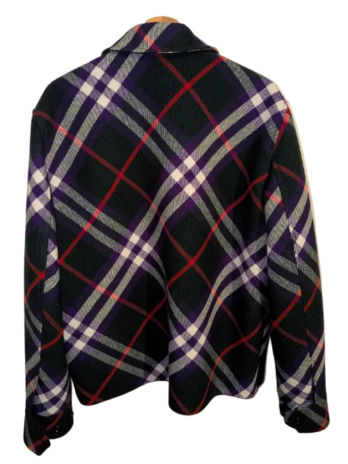 A black and red plaid flannel shirt jacket with white and yellow stripes, hanging on a wooden hanger against a neutral background.