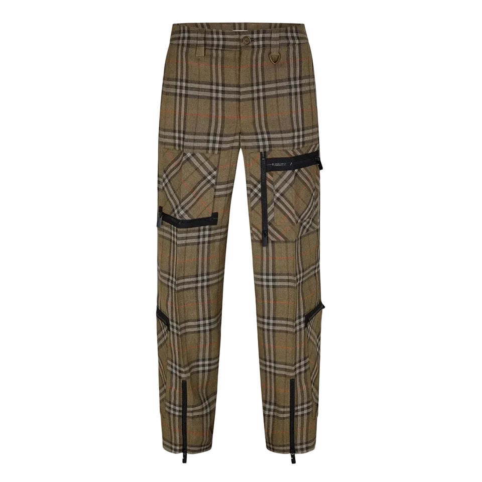 A pair of plaid trousers in a brown, beige, and black tartan pattern, featuring black cargo pockets with zippers and black drawstring details at the ankles, shown against a light gray background.