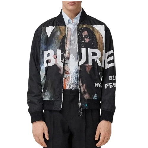 A man wearing a black bomber jacket with a large graphic print on the front that reads 'BURE' and 'HISTORIC'.