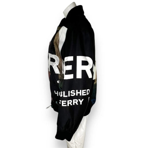 A black bomber jacket with large white text reading 'RER' and 'EOLISHED FERRY' on the side, displayed on a white mannequin against a plain white background.