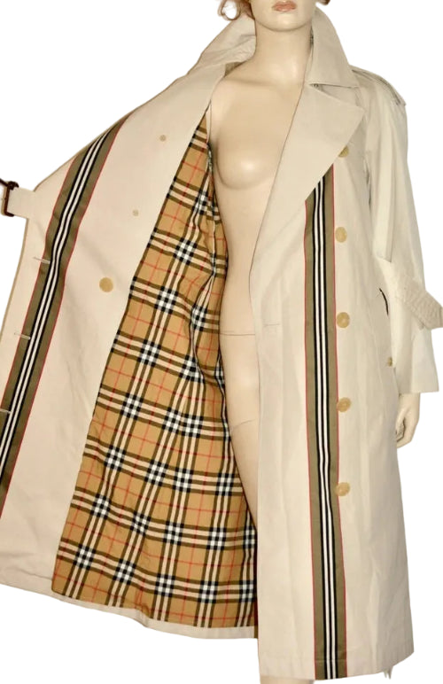 A beige trench coat displayed on a mannequin, shown open to reveal a classic tartan plaid lining in tan, beige, black, and white.