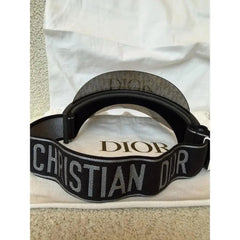 Black Dior belt on a white background