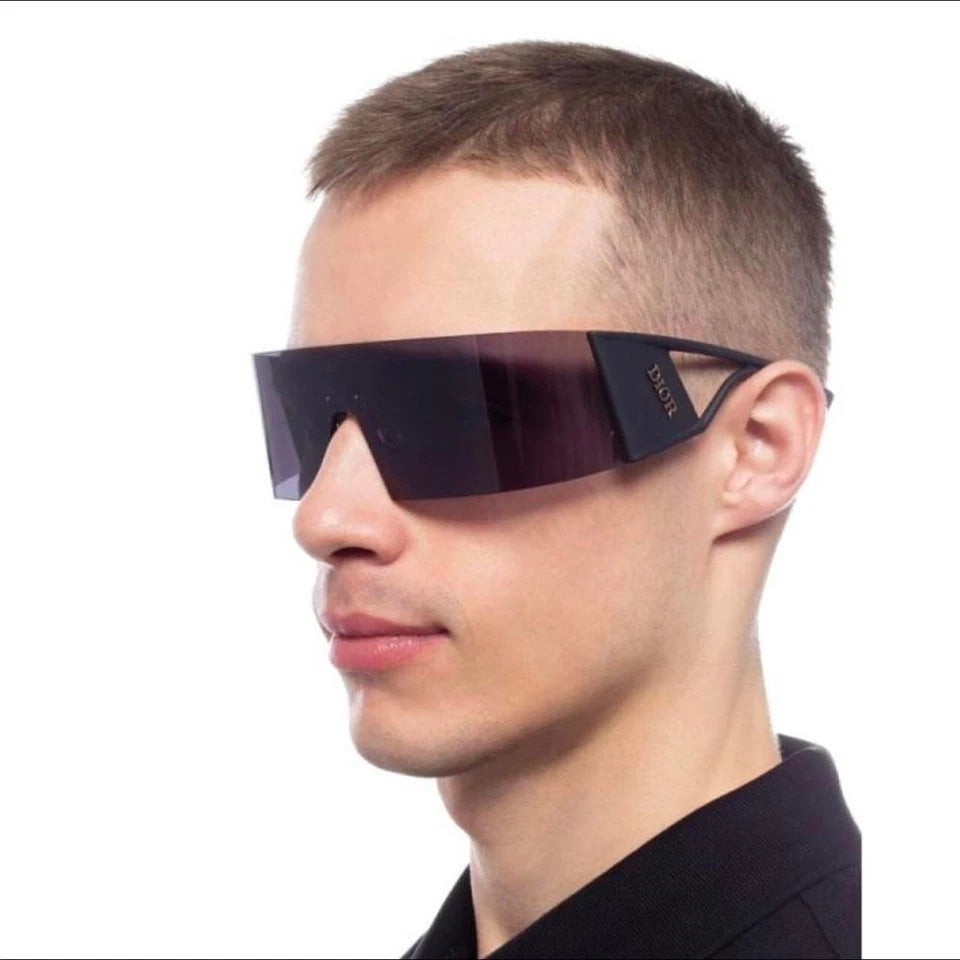 Person wearing futuristic sunglasses with a dark background