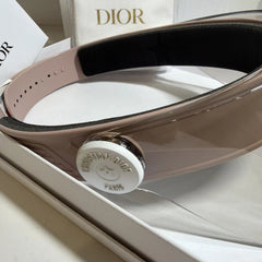 Close-up of a Dior belt with a clear plastic bag in the background