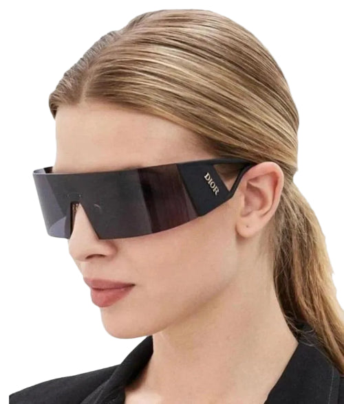 Woman wearing black sunglasses with 'Dior' logo on a white background