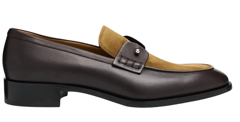 A dark brown leather penny loafer with a tan suede vamp, featuring a decorative leather strap with a silver-tone rivet and a low black block heel, shown from a side profile on a light gray background.