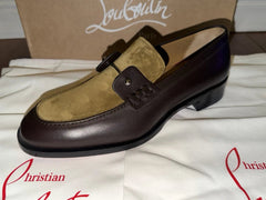 A men's lace-up oxford shoe in dark brown and tan leather, shown on a white surface with a brown shoebox in the background. The brand name 'Majestic' is visible on the box.