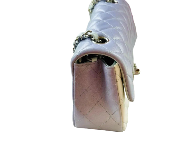 White sneaker with a colorful sole on a white surface