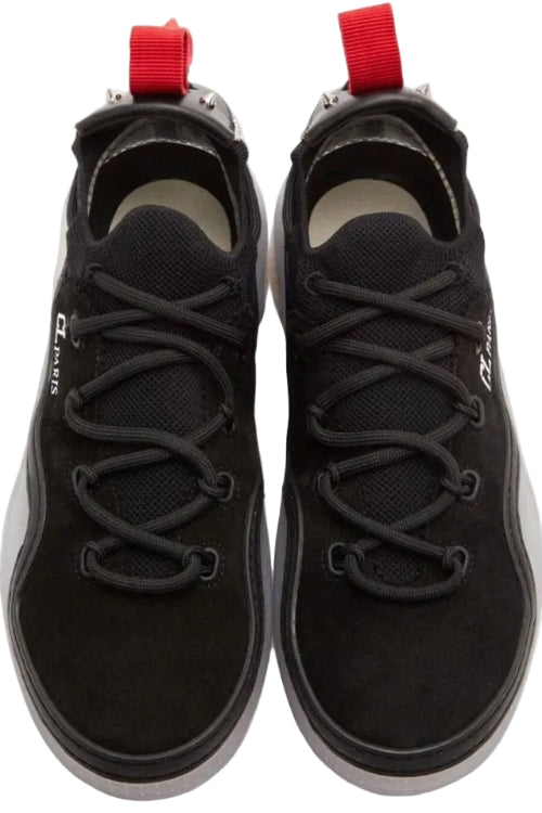 A pair of black low-top sneakers shown from a top-down view on a white background. The shoes feature black laces, a black mesh and suede upper, a red pull tab at the heel, and a white brand logo on the side.