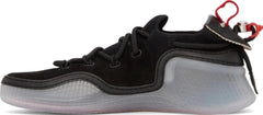 A black low-top sneaker with a thick translucent gray and white sculpted sole, black laces, and a red pull tab on the heel.