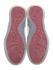A pair of white sneakers shown from a top-down view, highlighting the pink and white textured soles with stylized script lettering.